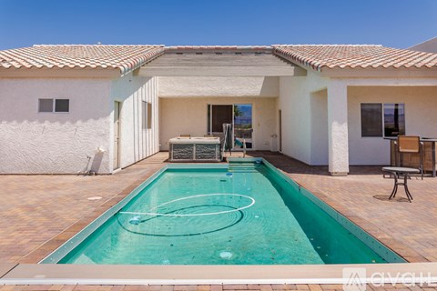 A small pool in a house with a patio.