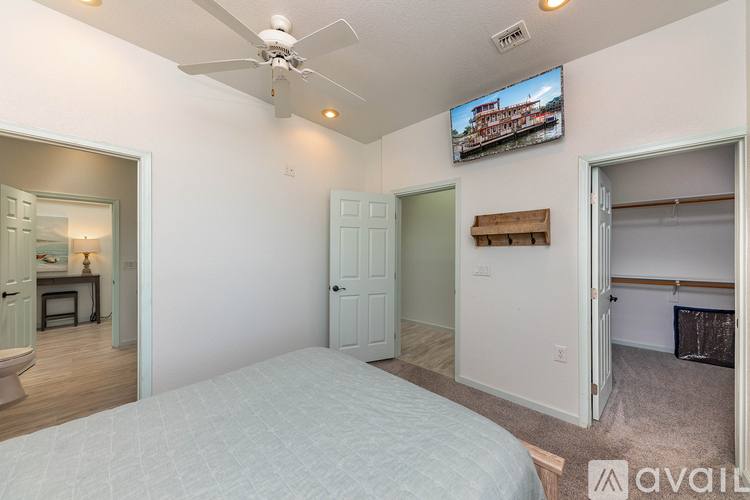 A bedroom with a bed, a television, and a closet.