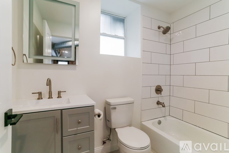 A bathroom with a toilet, sink, and tub.