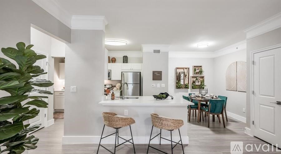 A well-lit kitchen with a dining table set for four.