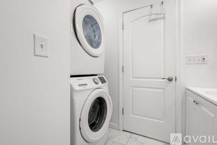 A white washing machine in a laundry room.