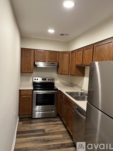 A kitchen with wooden cabinets and stainless steel appliances.
