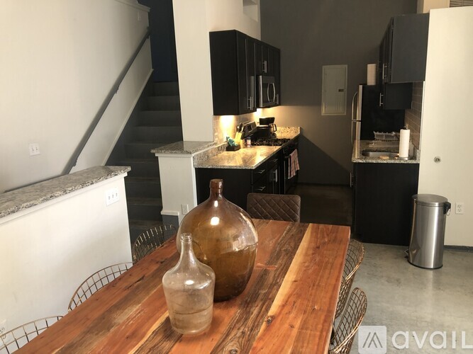 A kitchen with a wooden table and a vase on it.