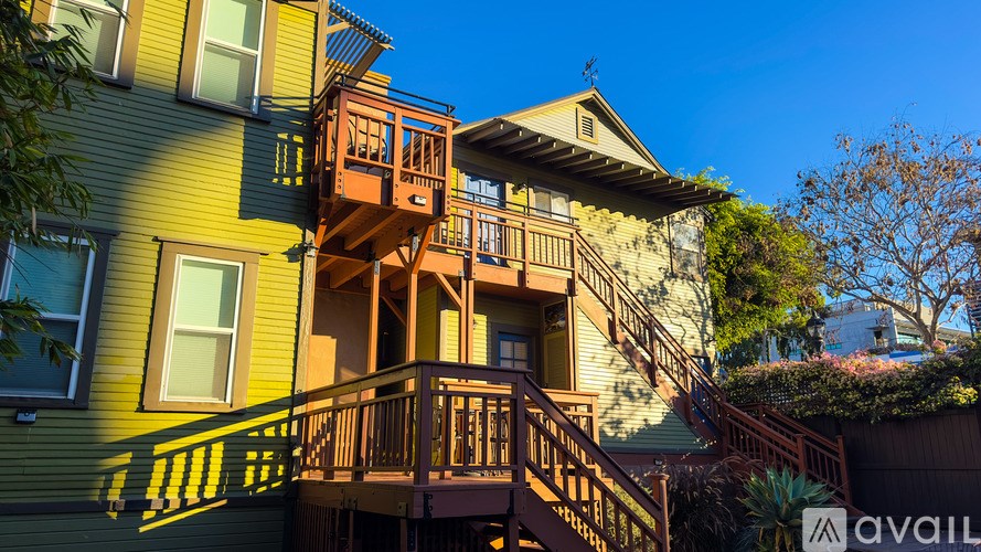 A house with a green exterior and a balcony.