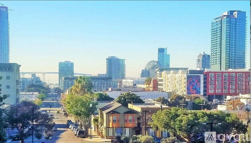 A cityscape with a mix of residential and commercial buildings.