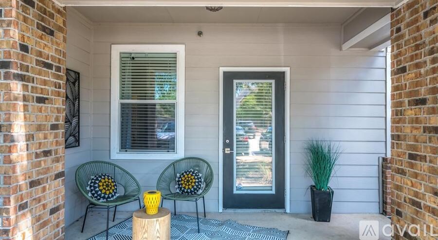 A patio with two chairs and a table with a yellow object on it.