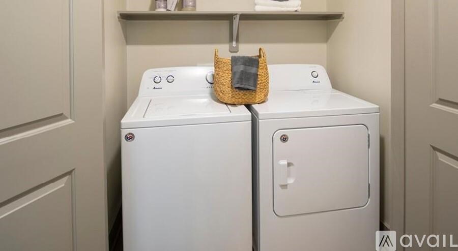 A white washing machine with a basket on top of it.