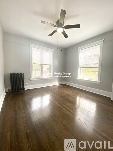 A room with wooden floors and a ceiling fan.