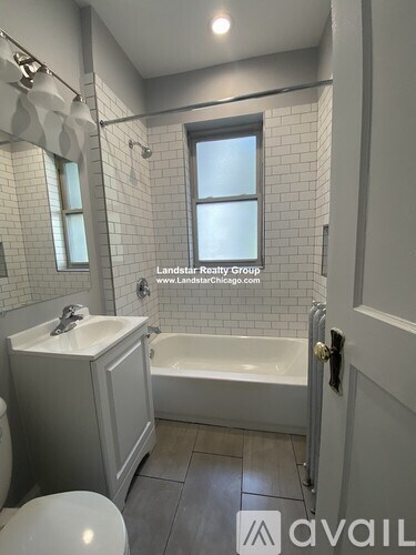 A white bathroom with Landstar Realty Group logo.