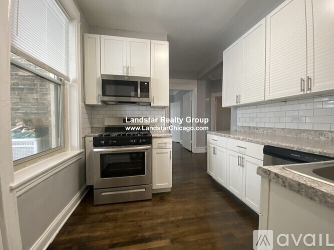 A kitchen with white cabinets and a stainless steel oven.