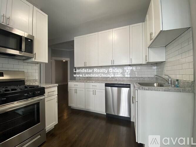 A kitchen with white cabinets and a stainless steel dishwasher.