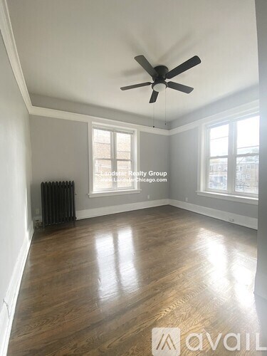 A room with wooden floors and a ceiling fan.