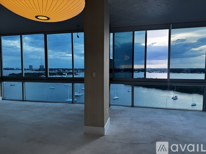 A room with a large window overlooking a body of water.