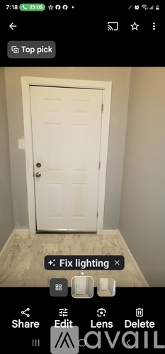 A white door in a room with a light switch and a lighting adjustment option.