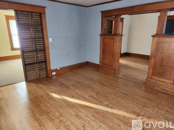 A room with wooden floors and a wooden door.