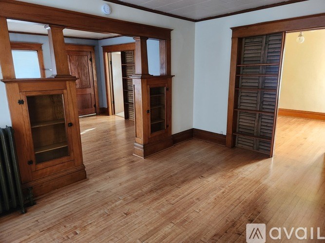 A room with wooden floors and furniture.