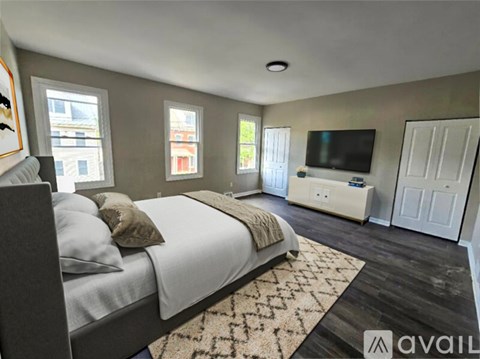 A room with a fireplace and wood flooring.