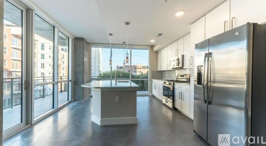 A modern kitchen with stainless steel appliances and a view of the city.