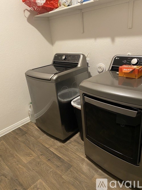 A kitchen with a black oven and a black trash can.