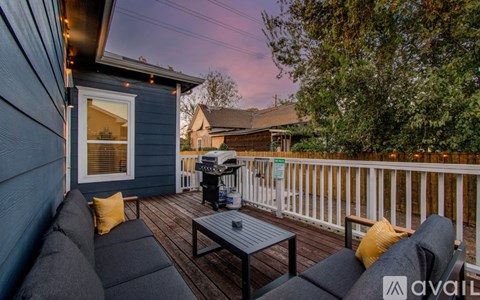 A patio with a table and chairs is set up on a deck.