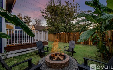 A backyard with a fire pit and seating area.