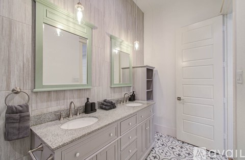 A bathroom with a sink, mirror, and towel rack.