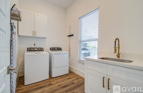 A small laundry room with a washer and dryer.