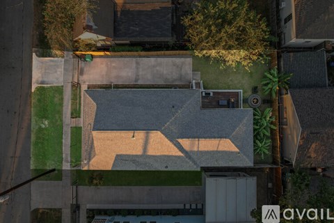 A basketball court is located in the middle of a grassy area.