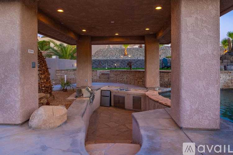 A modern outdoor space with a pool and a stone wall.