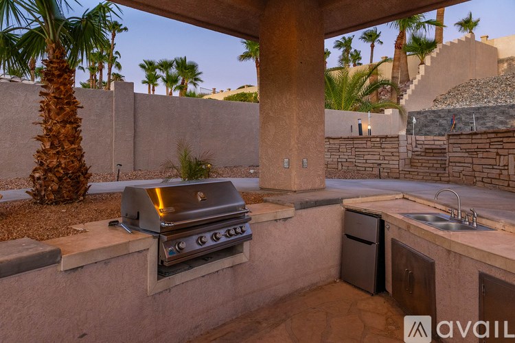 A patio with a grill and a sink.