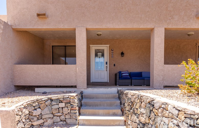 A house with a white door and a stone wall.