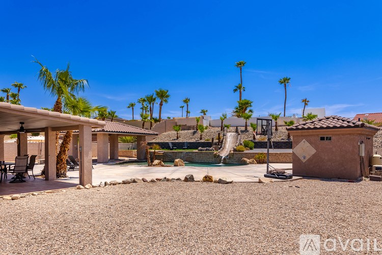 A backyard with a pool and a slide.