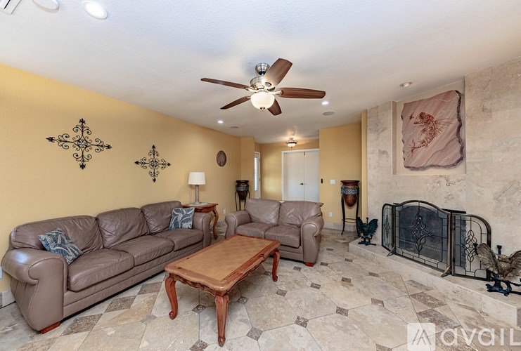 A living room with a brown couch and a wooden coffee table.