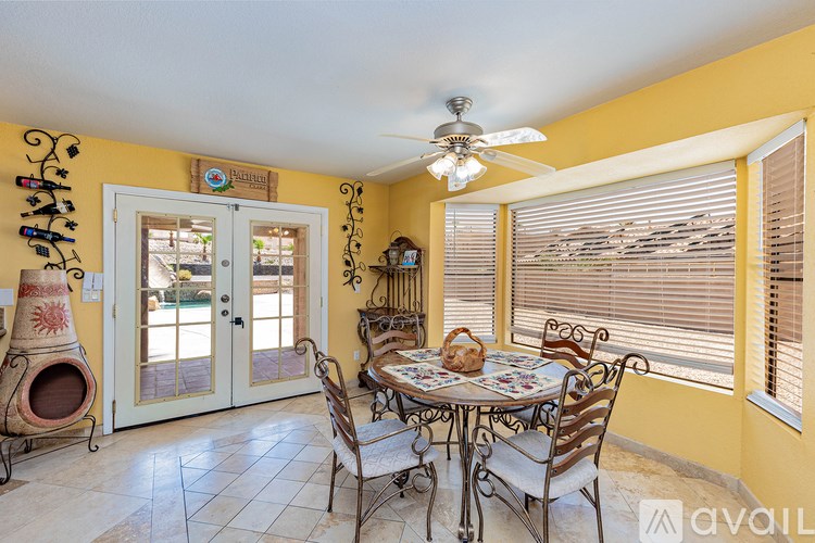 A dining room with a table set for four.