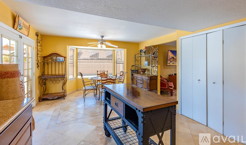 A kitchen with a table and chairs in the middle of the room.