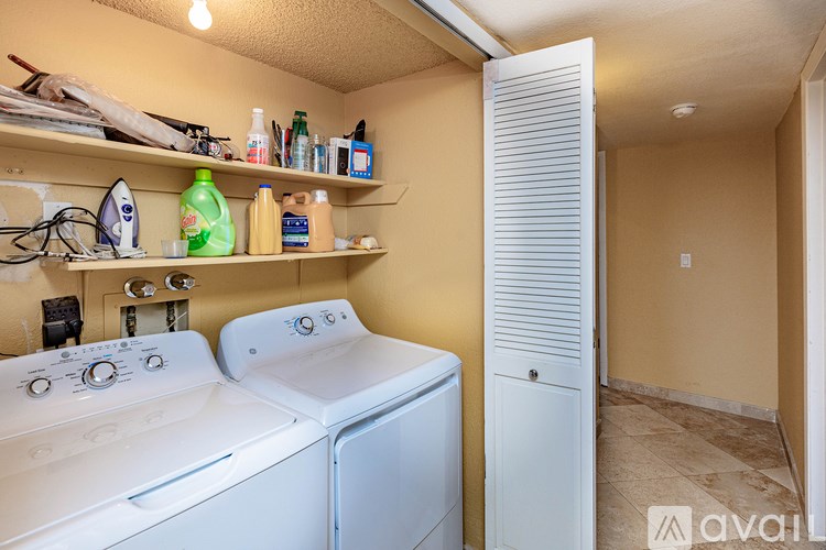 A small laundry room with a washer and dryer.