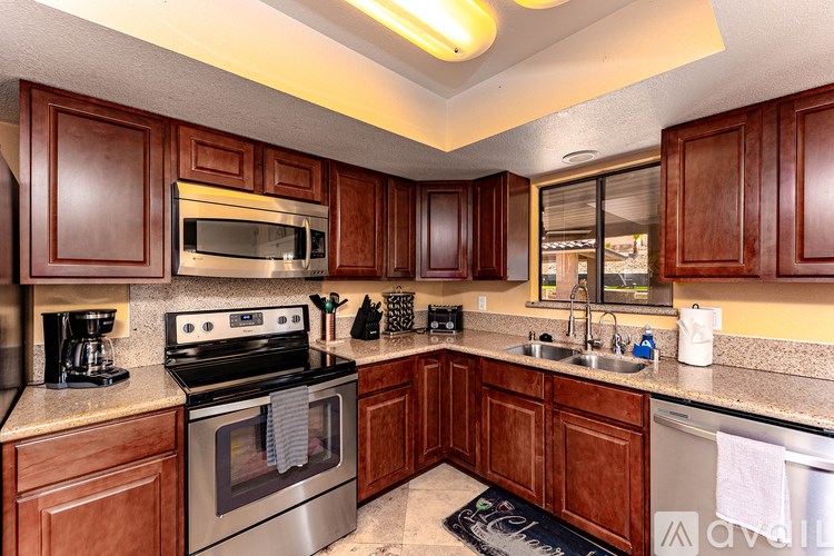 A kitchen with wooden cabinets and stainless steel appliances.
