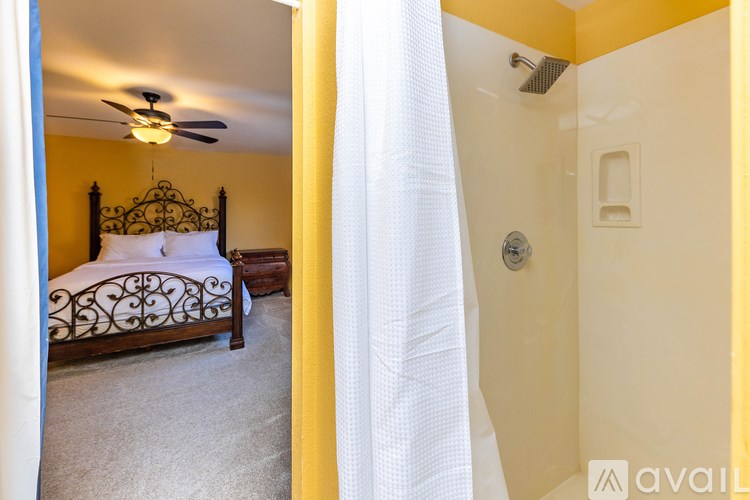 A bedroom with a bed and a shower.