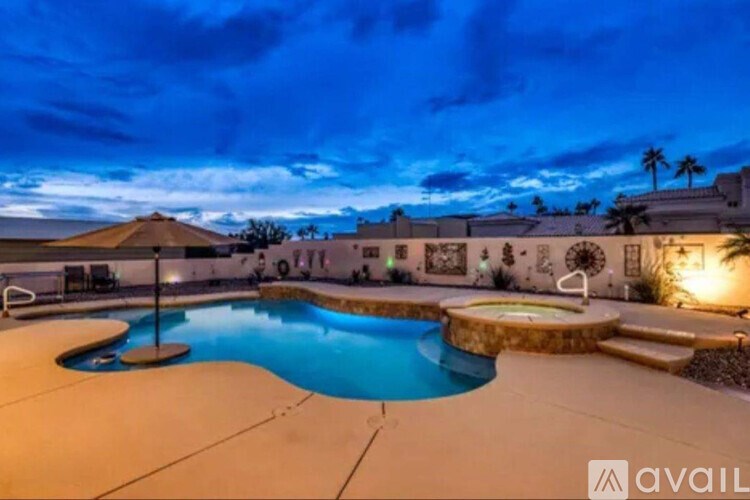 A pool with a waterfall and a water slide.