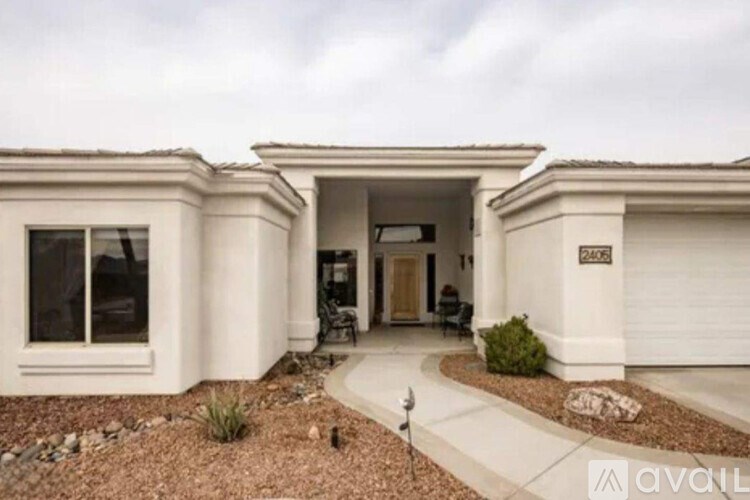 A house with a driveway and a sign that says "AVAIL" on it.