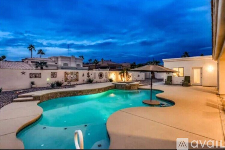 A pool with a hot tub in the middle of it.