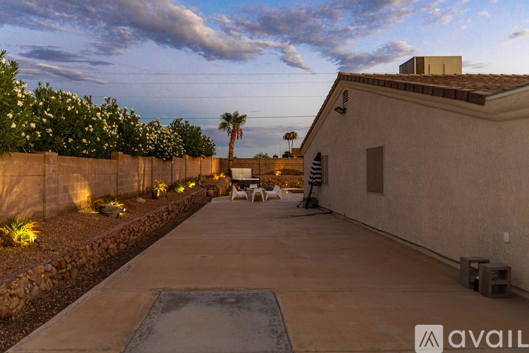 A patio area with a table and chairs is set up outside a house.