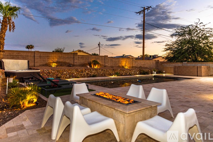 A modern outdoor dining area with a table and chairs.