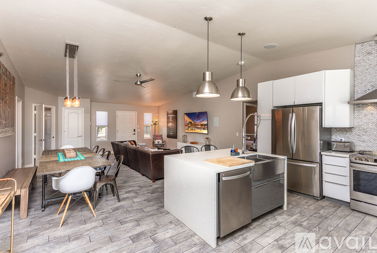 A modern kitchen with a dining table and chairs.