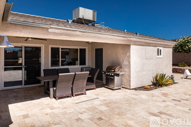 A patio area with a table and chairs is shown.