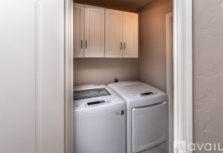 A small laundry room with a washer and dryer.