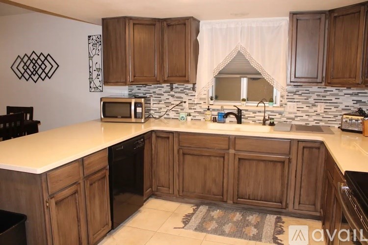 A kitchen with wooden cabinets and a white countertop.