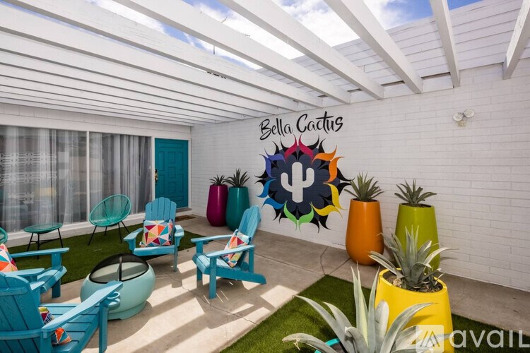A sunroom with a white ceiling and a sign that says Bella Cactus.