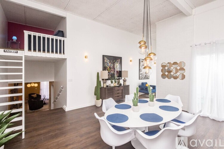 A white and blue dining table with a white and blue couch in a room.