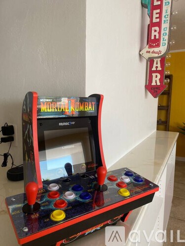 A Mortal Kombat arcade machine sits on a table.